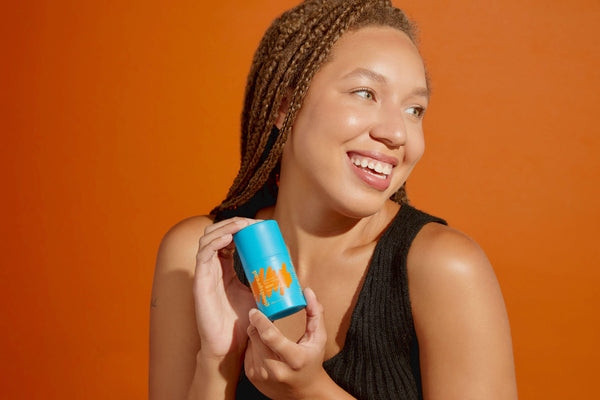 Heavy moisturizer being held by a woman